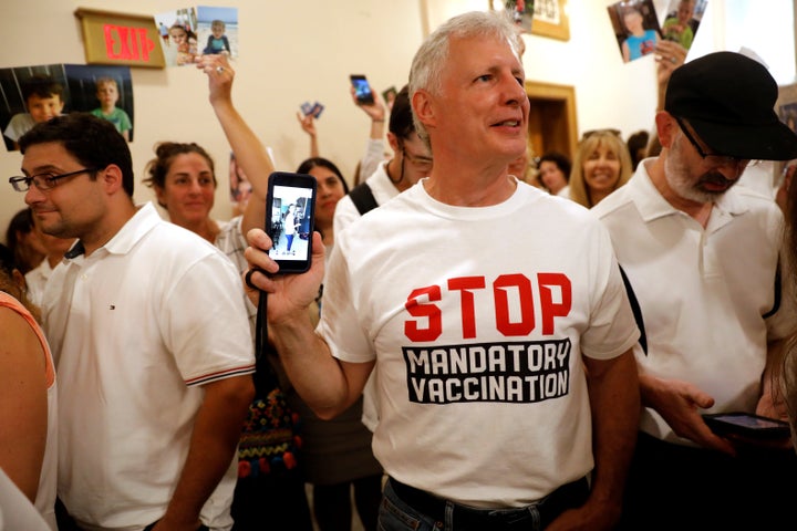 A crowd of people supporting a religious exemption to childhood vaccinations pack a hallway inside the New York state Supreme Court.