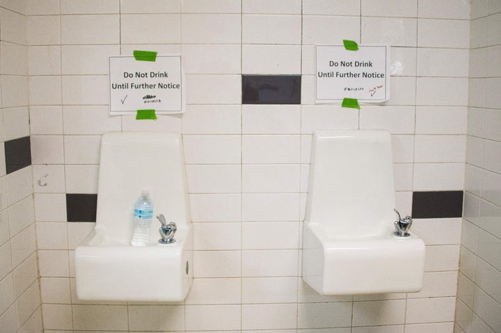 Placards posted above water fountains warn against drinking the water at Flint Northwestern High School in Flint, Michigan, o