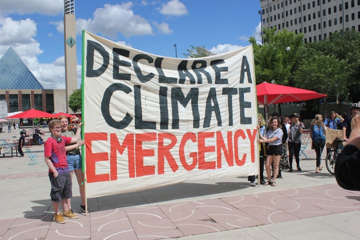 Student protesters hold up a banner that says "declare a climate emergency" during a march in Edmonton on June 28. 