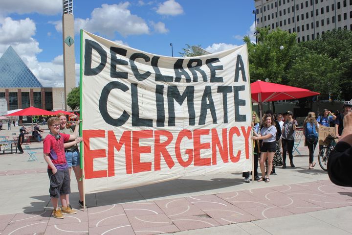 Student protesters hold up a banner that says "declare a climate emergency" during a march in Edmonton on June 28. 