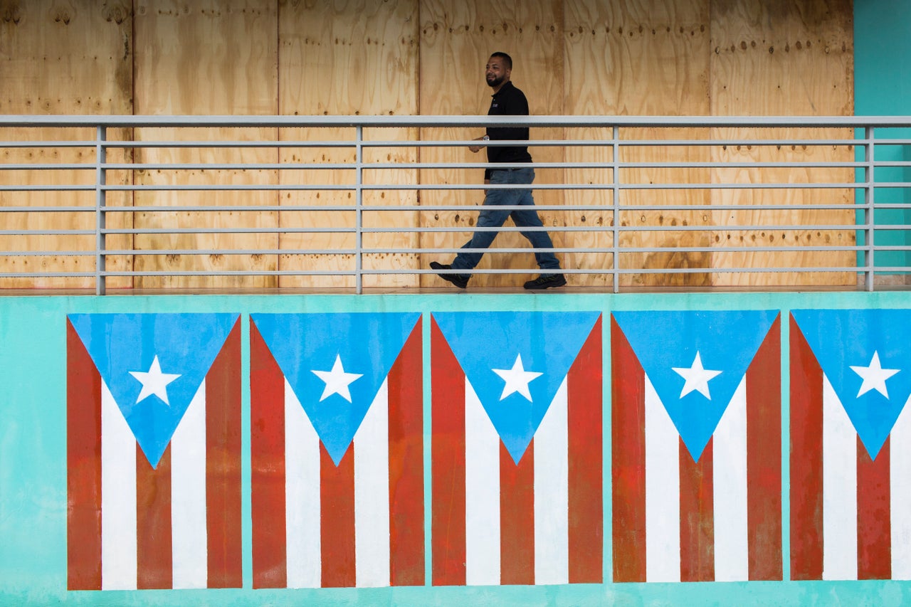 A man finish boarding up restaurant at the Naguabo Malecon. Puerto Rico prepares to receive the hit of Tropical Storm Dorian today August 28, 2019 in Naguabo, Puerto Rico. Tropical Storm Dorian will be the first major storm to hit the Island after the 2017 Hurricane Maria.Photo by Dennis M. Rivera Pichardo for The Huffington Post