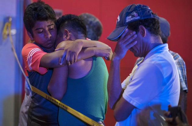 TOPSHOT - People react outside a bar where 23 people were killed by a fire in Coatzacoalcos, Veracruz on August 28, 2019. - At least 23 people were killed and 13 badly wounded in a fire at Caballo Blanco bar (White Horse bar) in eastern Mexico that is being investigated as an attack according to Mexican authorities. (Photo by ANGEL HERNANDEZ / AFP)        (Photo credit should read ANGEL HERNANDEZ/AFP/Getty Images)