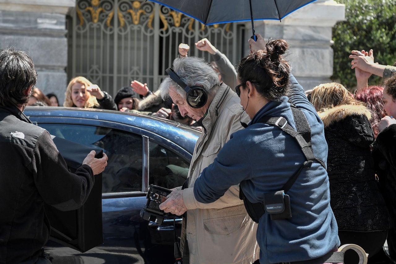 Greek-French film director Costas-Gavras (C) looks at a monitor during the shooting of the film 'Adults in the room' in central Athens on April 11, 2019. - The political film is based on former Greek Finance minister Yanis Varoufakis' book. (Photo by Louisa GOULIAMAKI / AFP) (Photo credit should read LOUISA GOULIAMAKI/AFP/Getty Images)