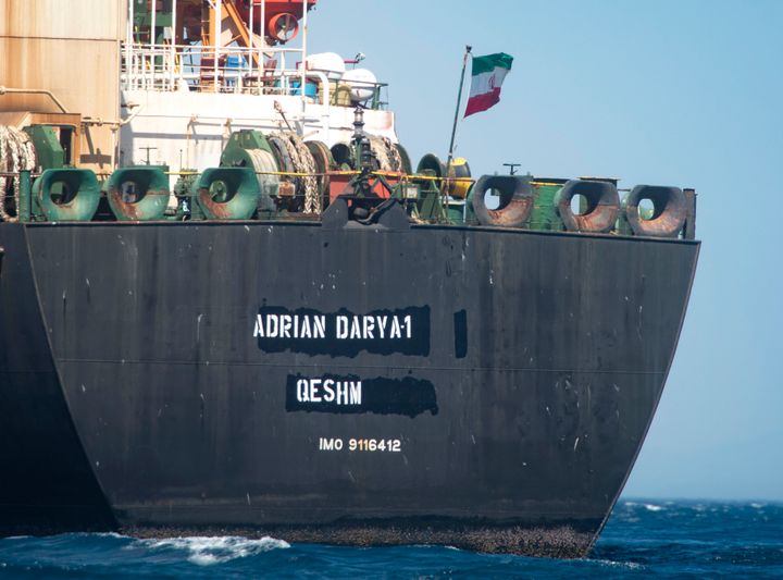 Renamed Adrian Aryra 1 super tanker hosting an Iranian flag, is seen on the water in the British territory of Gibraltar, Sunday, Aug. 18, 2019. Authorities in Gibraltar on Sunday rejected the United States' latest request not to release a seized Iranian supertanker, clearing the way for the vessel to set sail after being detained last month for allegedly attempting to breach European Union sanctions on Syria. (AP Photo/Marcos Moreno)