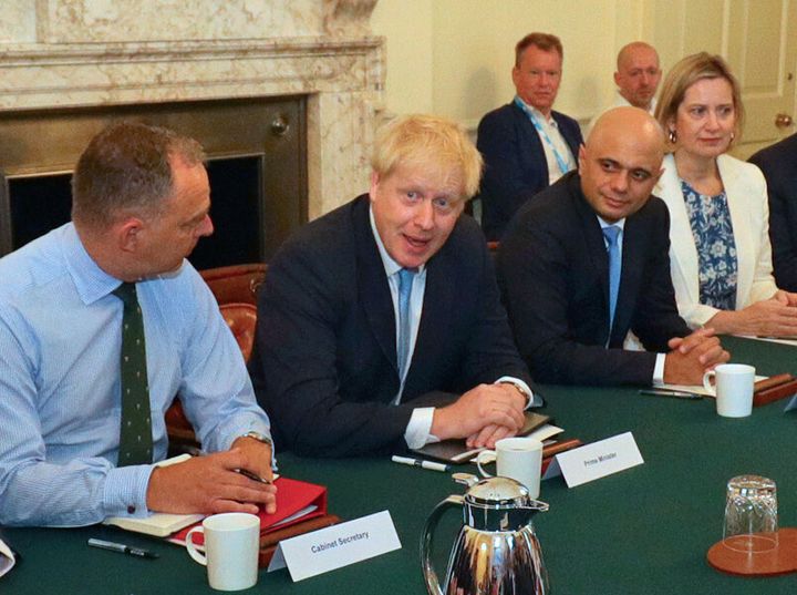 Cabinet Secretary Sir Mark Sedwill, Prime Minister Boris Johnson, Chancellor of the Exchequer Sajid Javid, Works and Pensions Secretary and Minister for Women Amber Rudd, and Lee Cain (back right) as the PM holds his first Cabinet meeting at Downing Street in London.