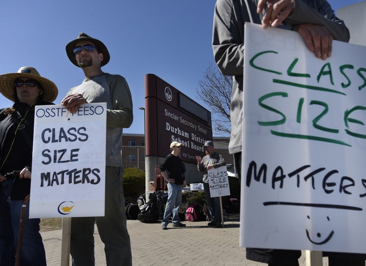 Teachers walk the picket line outside Sinclair Secondary School in Whitby, Ont. on April 28, 2015.