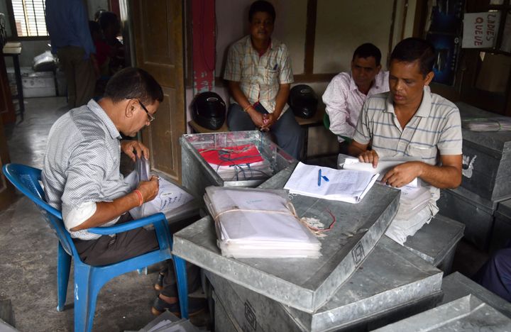 Workers at the National Register of Citizens office check documents submitted by people for the NRC ahead of the release of the register's final draft in Guwahati, Assam.