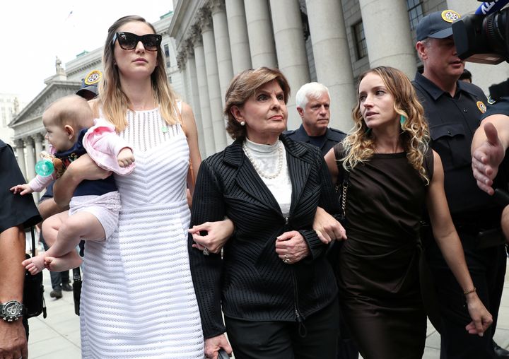 Gloria Allred, representing alleged victims of Jeffrey Epstein, leaves with Teala Davies and an unidentified women and baby after the hearing in the criminal case against Epstein.