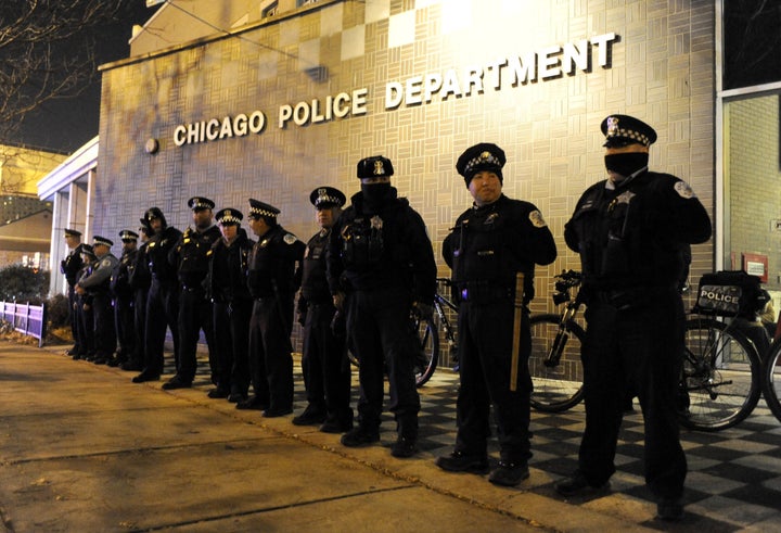 In this Nov. 24, 2015, file photo, Chicago police officers line up outside the District 1 central headquarters in Chicago, during a protest for the fatal police shooting of 17-year-old Laquan McDonald. (AP Photo/Paul Beaty File)