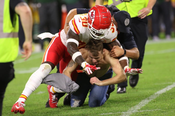 Kansas City Chiefs defensive back Harold Jones-Quartey helps the Green Bay Police Department tackle a fan who ran on the field during a game between the Green Bay Packers and the Kansas City Chiefs at Lambeau Field on Aug. 29.