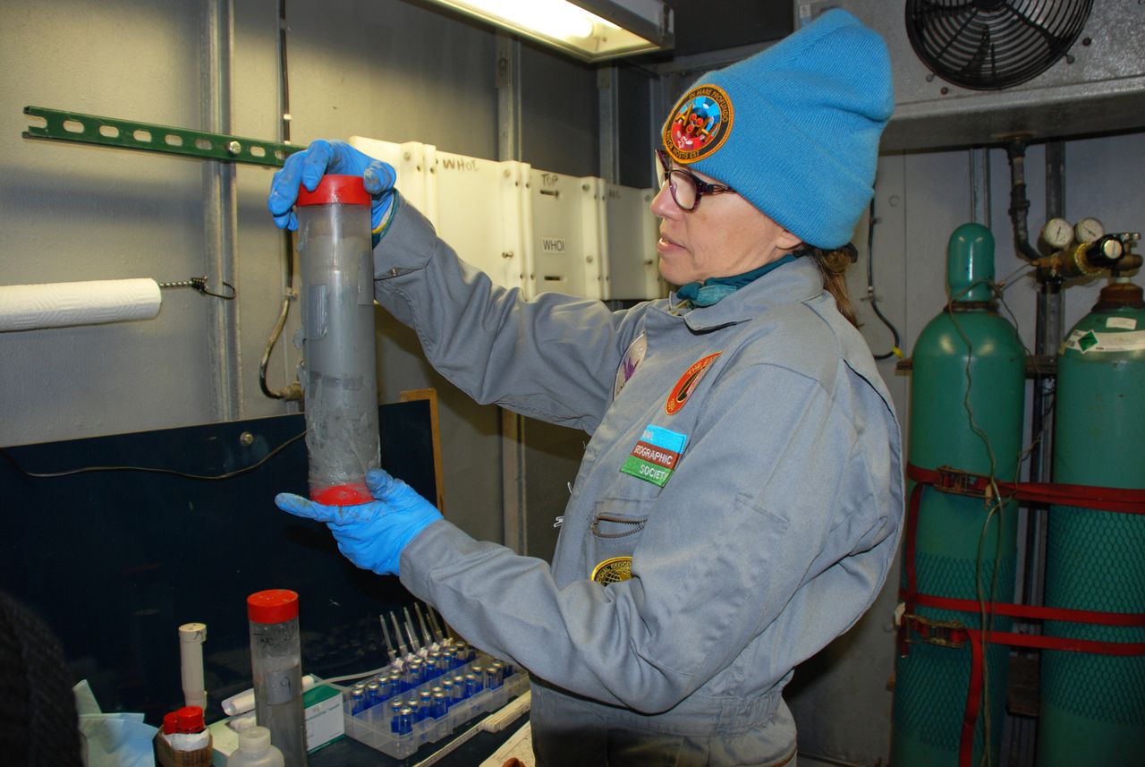 Samantha Joye inspects a core of marine sediment aboard Atlantis.