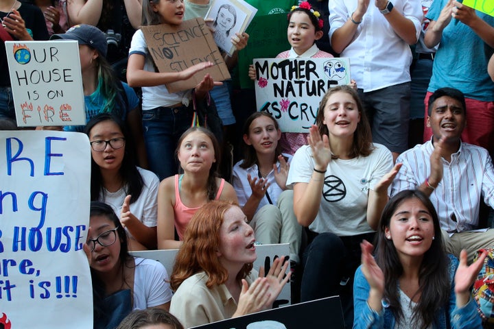 Swedish environmental activist Greta Thunberg, center left, participates in a youth climate strike outside the United Nations
