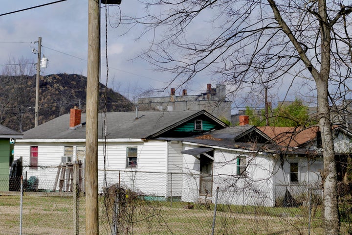 The view from the alley behind activist Keisha Brown's street where mounds of industrial waste obstruct the view of the coke plant beyond.