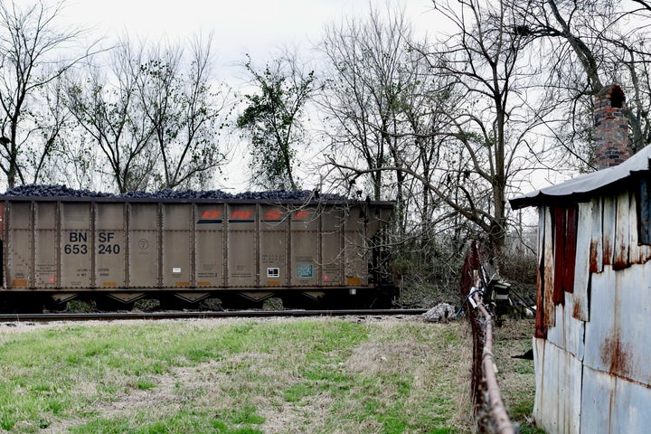 Carloads of uncovered coal product sit for hours in Harriman Park.