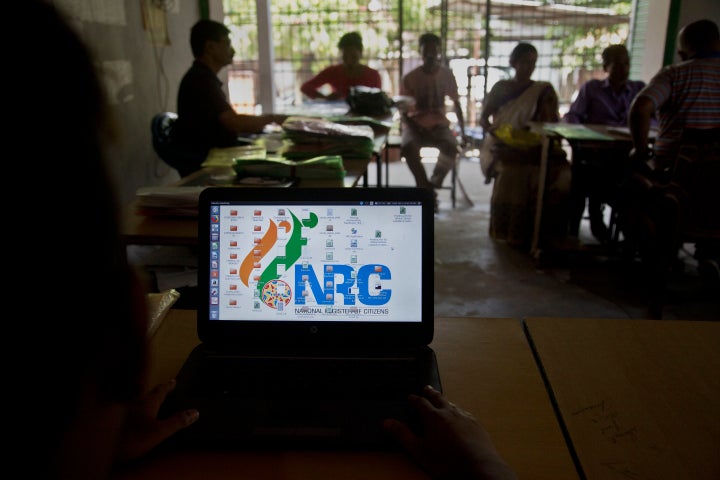 National Register of Citizens (NRC) officers attend to people in an NRC center on the eve of the release of the final NRC draft on the outskirts of Gauhati, India, Friday, Aug. 30, 2019. India on Saturday, Aug. 31 plans to publish a controversial citizenship list that advocates say will help rectify decades of unchecked illegal immigration into the northeastern state of Assam from Bangladesh. Critics fear it will leave off millions of people, rendering them stateless. (AP Photo/Anupam Nath)