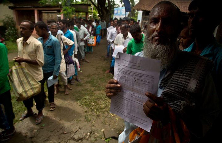 People whose names were left out in the National Register of Citizens (NRC) draft stand in a queue to collect forms to file appeals near a NRC center on the outskirts of Gauhati, India, Monday, Aug. 13, 2018. A draft list of citizens in Assam, released in July, put nearly 4 million people on edge to prove their Indian nationality. (AP Photo/Anupam Nath)
