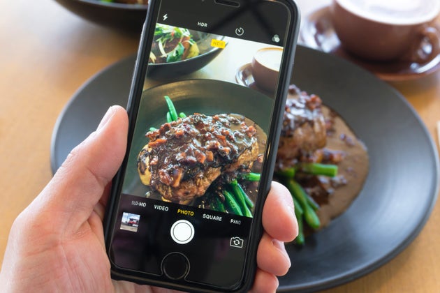 Melbourne, Australia - Oct 20, 2017: Taking picture of beef steak with smartphone