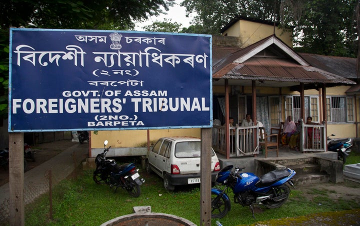 In this Aug. 28, 2019, photo, people wait at the Foreigner's Tribunal office in Barpeta, in the northeastern Indian state of Assam. India plans to publish a citizenship list in the northeastern state of Assam on Saturday, Aug. 31, that advocates hope will help rectify decades of illegal immigration from Bangladesh. Critics of the list worry it will leave millions of people stateless, leading to detention or deportation. Some cases have even led to suicide. (AP Photo/Anupam Nath)