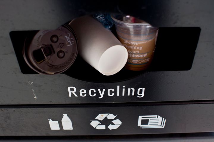 A recycling bin is stuffed with coffee cups on Yonge Street in downtown Toronto.