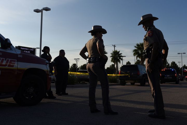 Texas state troopers and other emergency personnel monitor the scene at a local car dealership following a shooting in Odessa, Texas. 