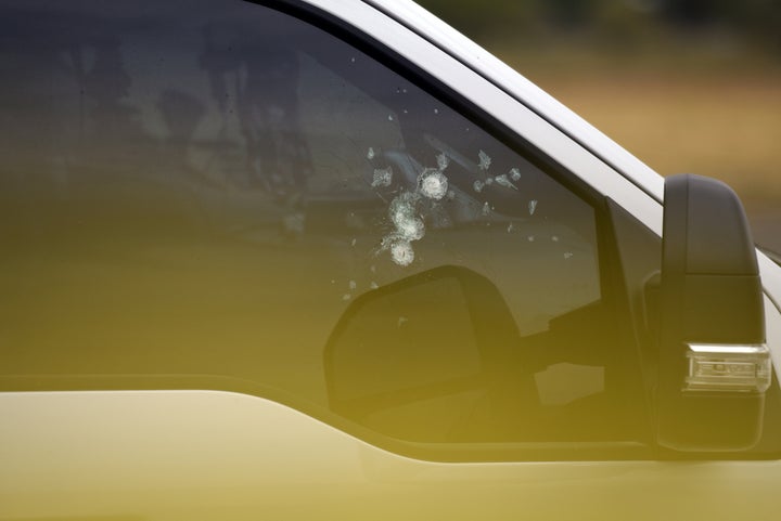 Bullet holes are seen in a car window near an Olive Garden restaurant following Saturday's shooting in Odessa, Texas.