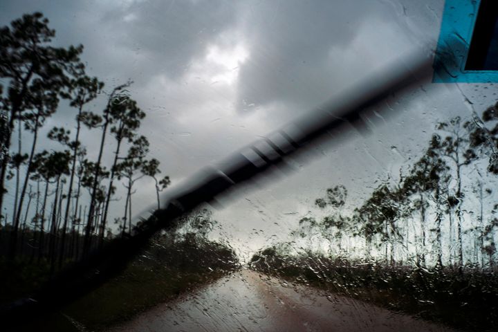A car returns to the capital under the previous rain before the arrival of Hurricane Dorian in Freeport, Grand Bahama, Bahamas, Sunday Sept. 1, 2019. (AP Photo/Ramon Espinosa)