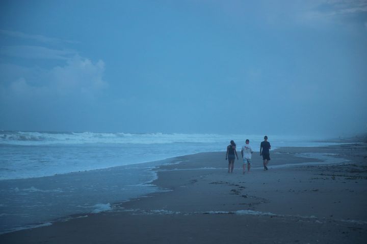 Visitors enjoy a final evening at the beach before a mandatory evacuation order goes into effect in the morning as Hurricane Dorian continues to make its way toward the Florida coast on September 1, 2019 in Indialantic, Florida. 