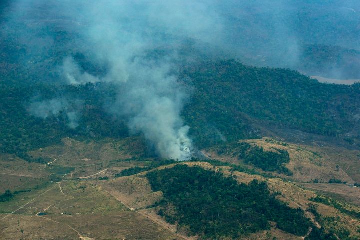 Smoke rises from a rainforest in Altamira, Para state, Brazil, Wednesday, Aug. 28, 2019. Brazilian President Jair Bolsonaro said Wednesday that Latin America's Amazon countries will meet in September to discuss both protecting and developing the rainforest region, which has been hit by weeks of devastating fires.(AP Photo/Leo Correa)