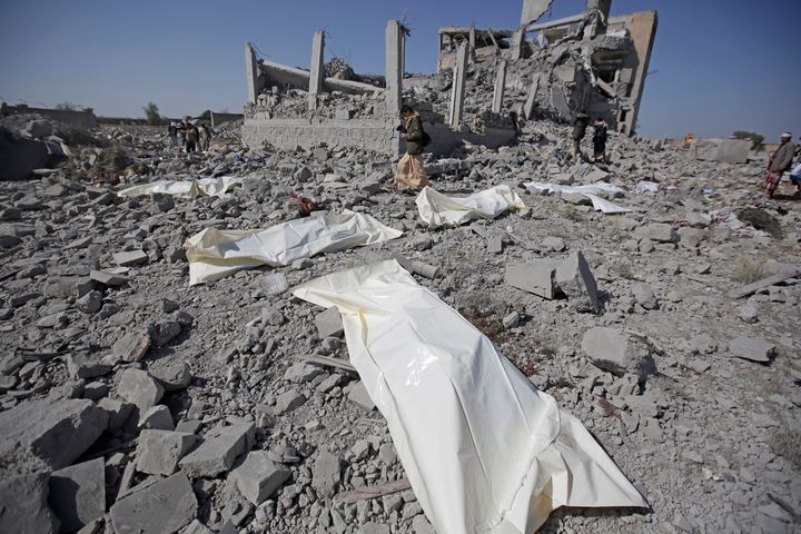 Bodies lie on the ground after being recovered from under the rubble of a Houthi detention center destroyed by Saudi-led airstrikes in Dhamar province, southwestern Yemen, Sunday, Sept. 1, 2019. 