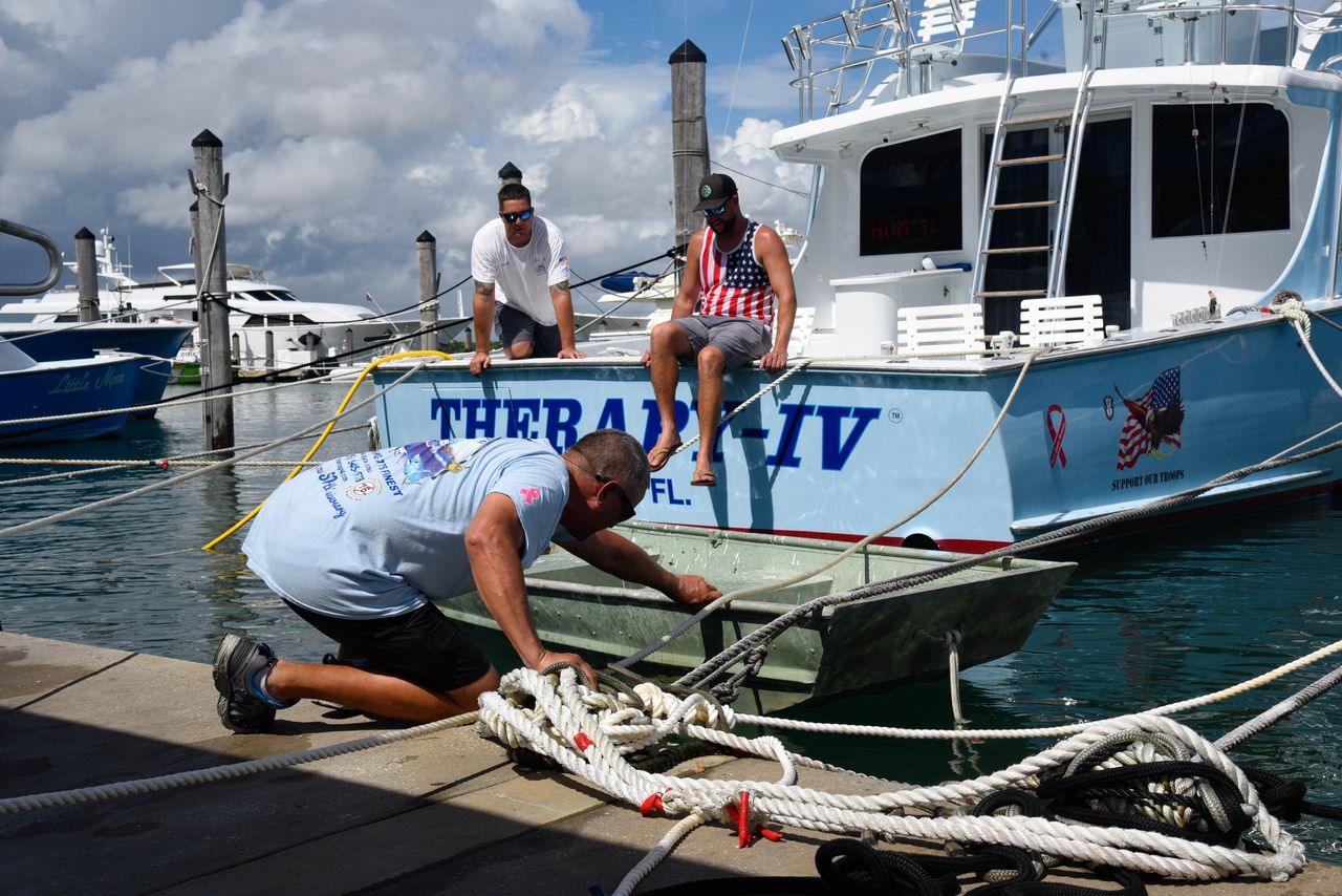 <strong>Boat workers Chris Bostwick, Mark and Mike Rodgriguez secure a boat at Haulover Marina in Haulover Beach, Florida, as they prepare for Hurricane Dorian on August 31.</strong>