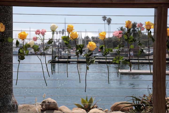 Flowers fixed to the railing at Truth Aquatics as a search continues for people missing in a pre-dawn fire that sank a commercial diving boat off an island near Santa Barbara, California.