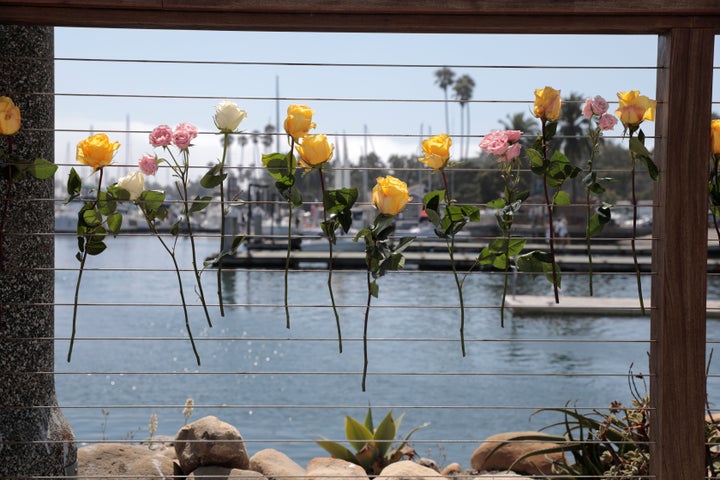 Flowers fixed to the railing at Truth Aquatics as a search continues for people missing in a pre-dawn fire that sank a commer