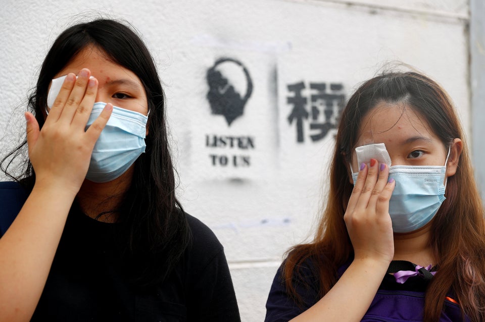 Students cover their eyes as they protest at Edinburgh Place in Hong Kong, China September 2, 2019. REUTERS/Kai
