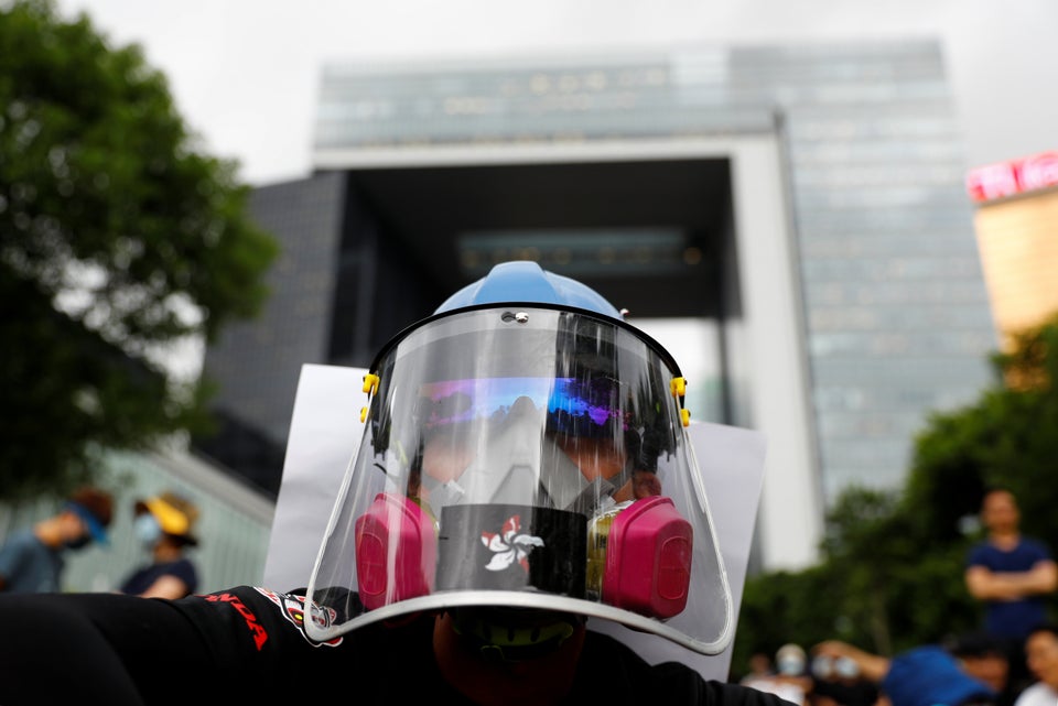 A protester takes part in a general strike at Tamar Park in front of the government buildings in Hong...