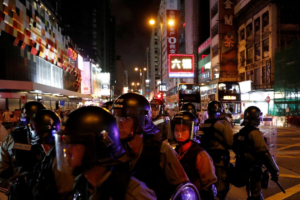 Riot police patrol streets near Mong Kok police station during an anti-extradition bill protest, in Hong...
