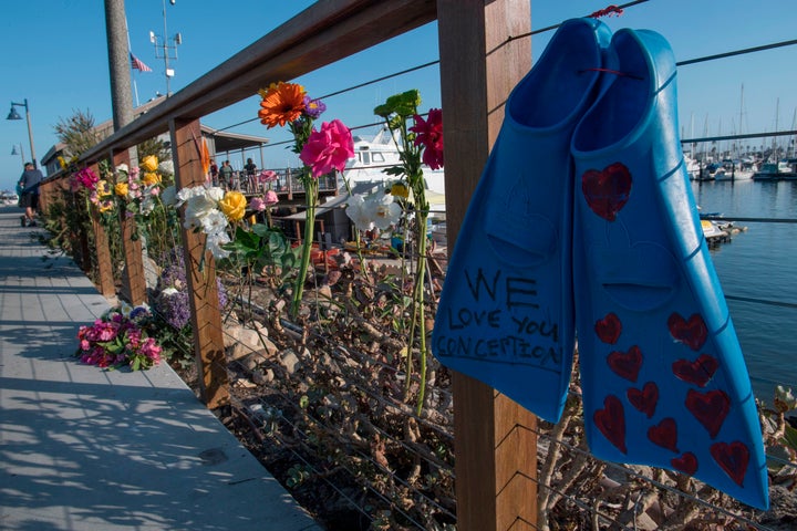 A pair of diving fins and flowers at a memorial wall near the Truth Aquatics moorings where the boat that burned and sank off the Santa Cruz islands early in the morning, was based in Santa Barbara, California on September 2, 2019.