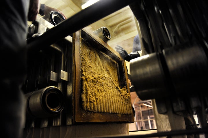 Spent grain comes out of the filter press after the wort has been sent along in the brewing process to make Colorado Native Lager in Golden, Colorado.