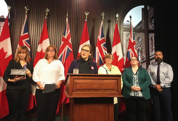 Laura Walton, president of a union council that represents 55,000 non-teaching staff at Ontario schools, speaks to reporters at Queen's Park on Sept. 3, 2019 with some of her members.