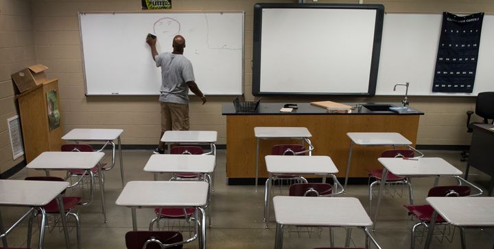 Gardendale High School biology teacher Justin Ingram readies his classroom before school begins in Gardendale, Alabama, on Aug. 4, 2016. Gardendale is a small city whose schools tried to secede from their larger district.