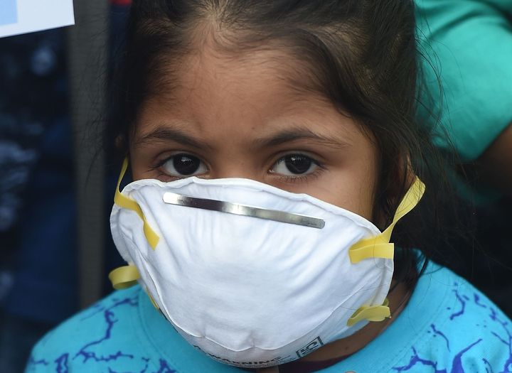 A girl wears a face mask to protect against air pollution in New Delhi on November 6, 2018