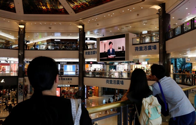 People watch a news conference of Hong Kong's Chief Executive Carrie Lam televised on a big screen in a shopping mall in Hong Kong, China, September 4, 2019. REUTERS/Anushree Fadnavis