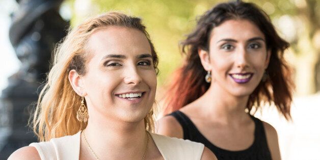 Two female transgender friends looking at camera, cheerful