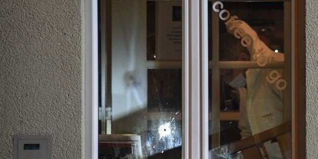 Police collect evidence at the site of a shooting on early March 10, 2017 in the city of Basel, north-west...