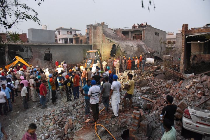Rescuers work at the site of an explosion at a fireworks factory in Batala, Punjab, Wednesday, Sept. 4, 2019. 