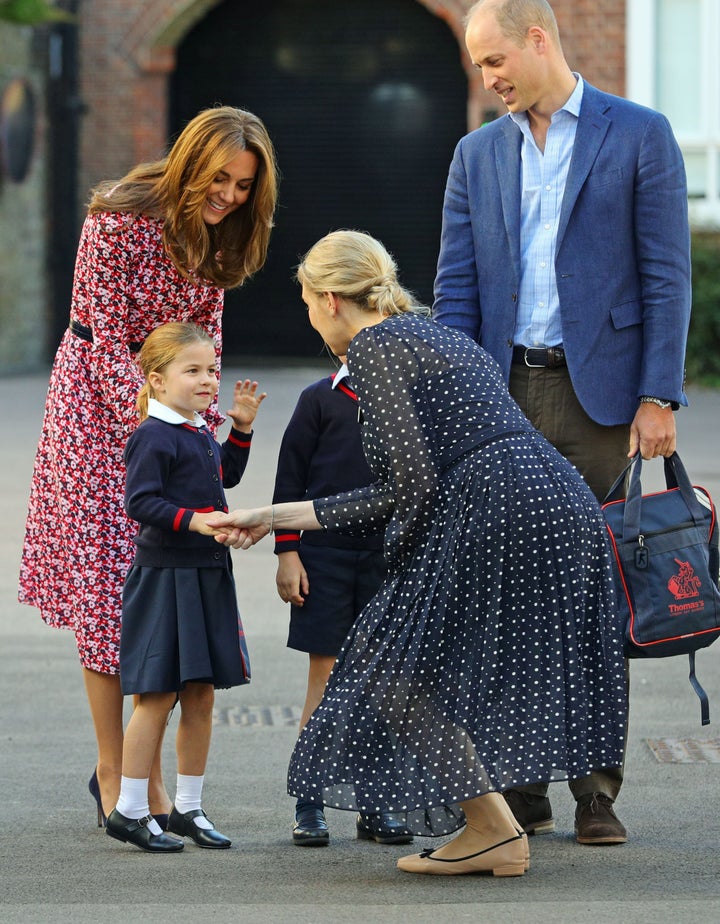 Charlotte is greeted by Helen Haslem, head of the lower school, on her arrival for her first day of school at Thomas's Battersea in London on Sept. 5.