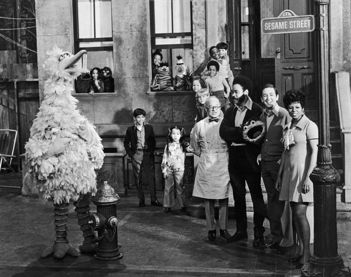 Sesame Street cast members posing on the set with some of the puppet characters and children, circa 1969. Left to right: Will Lee, Matt Robinson, Bob McGrath and Loretta Long.