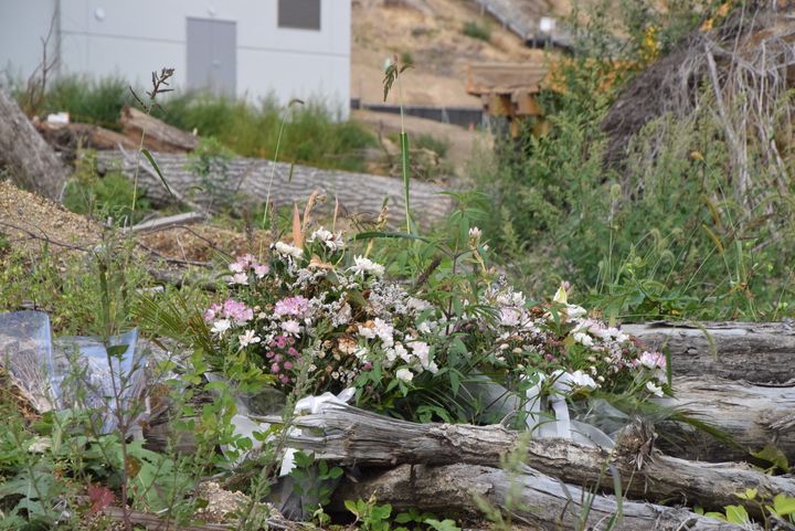 浄水場のあった場所には、家屋や施設だったがれきが積みあがっている。その手前には、いくつかの花が添えられていた＝2019年9月1日