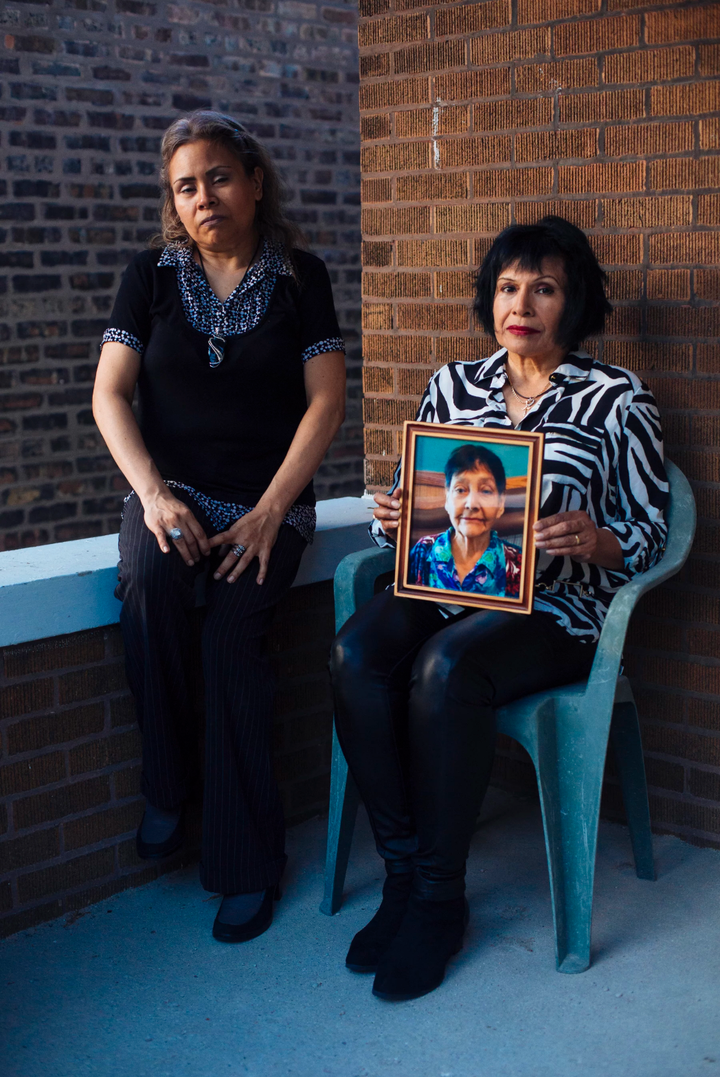 Eleanore Escamilla, left, with her sister Irma Escamilla, holding a photo of their mother, Telesfora Escamilla, who was in a Chicago crosswalk when an Amazon contractor made a left turn and hit her. (Taylor Glascock for ProPublica)