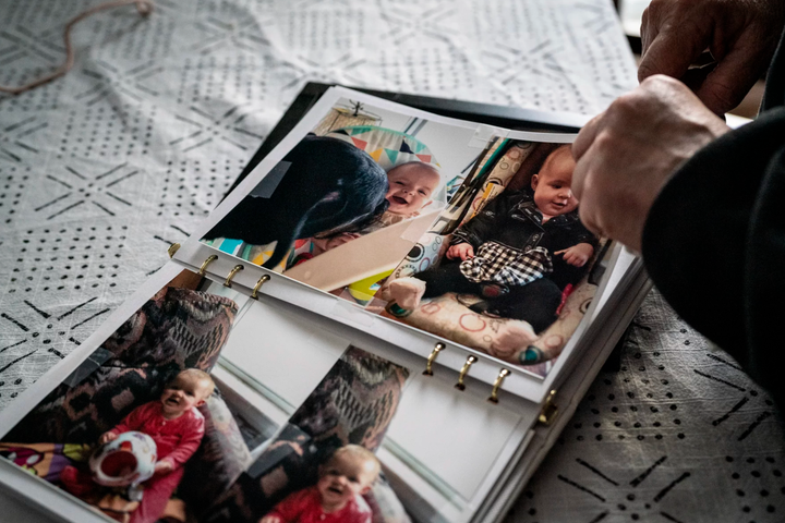 Judy Kennedy flips through pictures of her granddaughter Gabrielle Kennedy at her home in North Berwick, Maine. The baby was killed when a driver delivering Amazon packages crashed a 26-foot rented box truck into the back of her mother’s Jeep. (Sarah Rice, special to ProPublica)