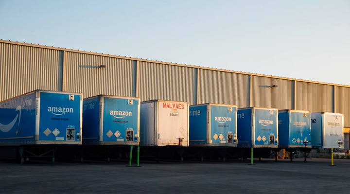 Tractor-trailers parked at an Amazon warehouse in Chicago, where they drop off goods to be picked up by fleets of cars, trucks and cargo vans that often bear no mark of the company. (Taylor Glascock for ProPublica)